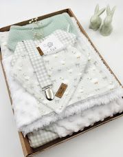 Baby gift box set with sage green bib, floral blanket, dummy clip, and ceramic bunny ornaments.