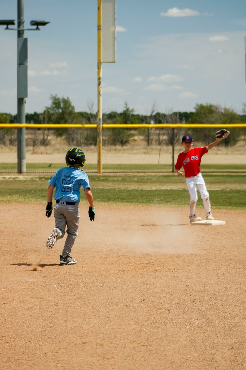 Young boys playing Little League Baseball during a sports photography session in Amarillo, Texas