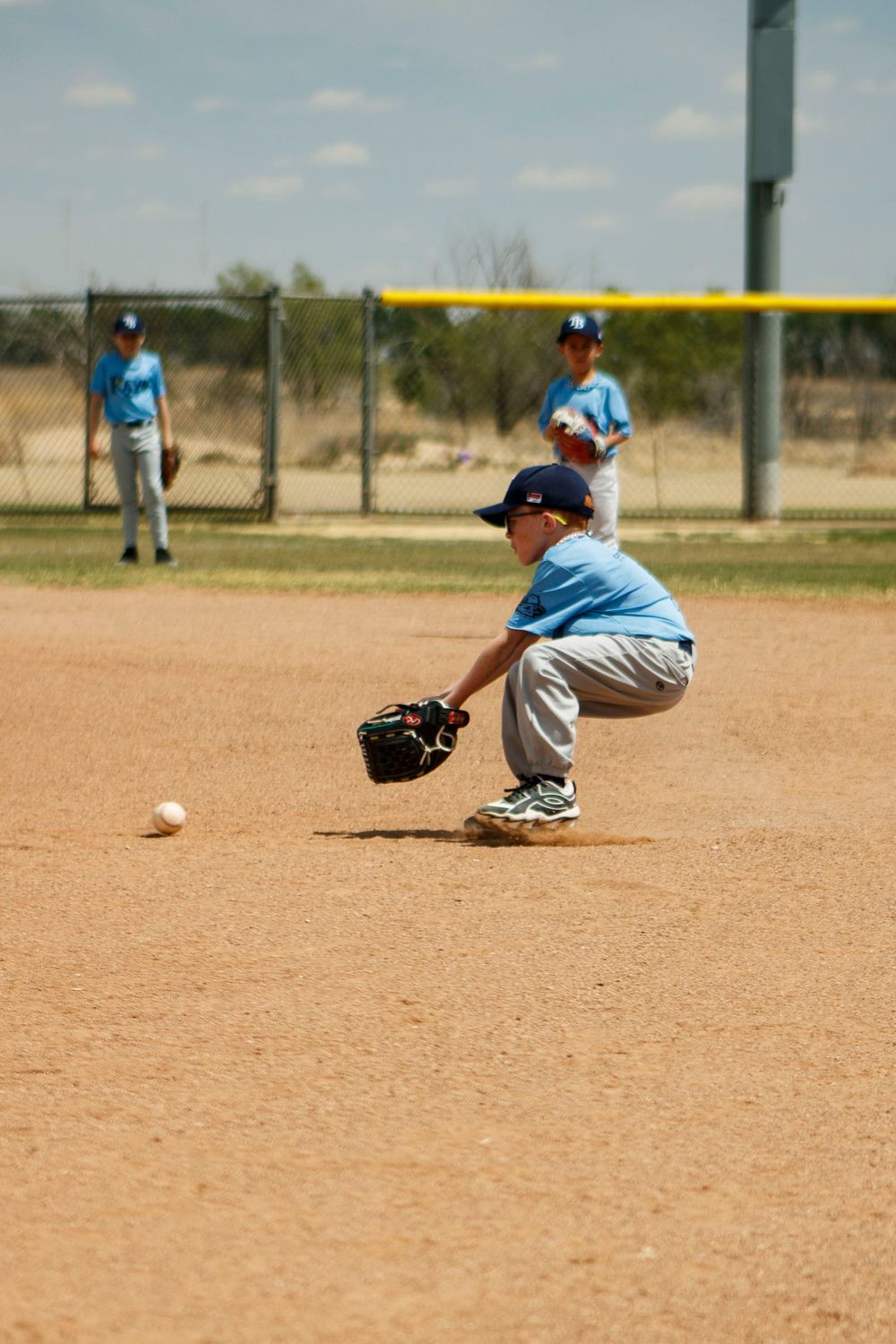 Young boys playing Little League Baseball during a sports photography session in Amarillo, Texas