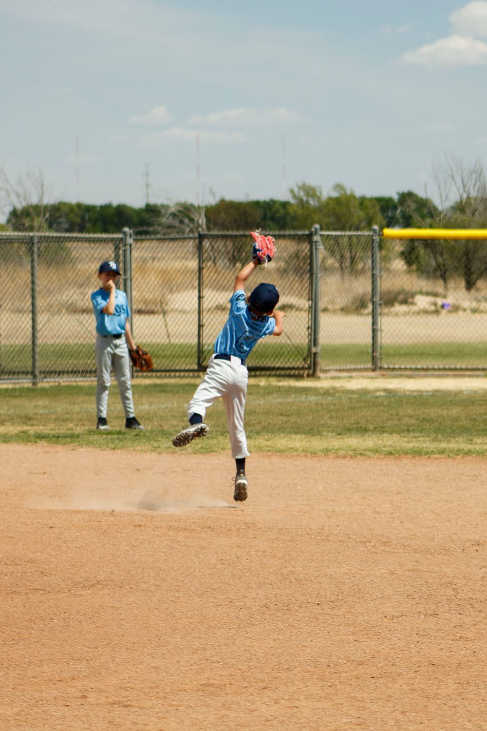 Young boys playing Little League Baseball during a sports photography session in Amarillo, Texas