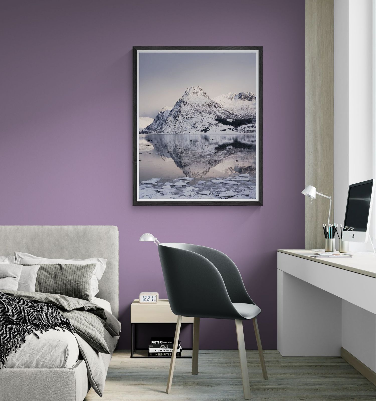 Framed monochrome mountain reflection print displayed on a purple bedroom wall above a desk.