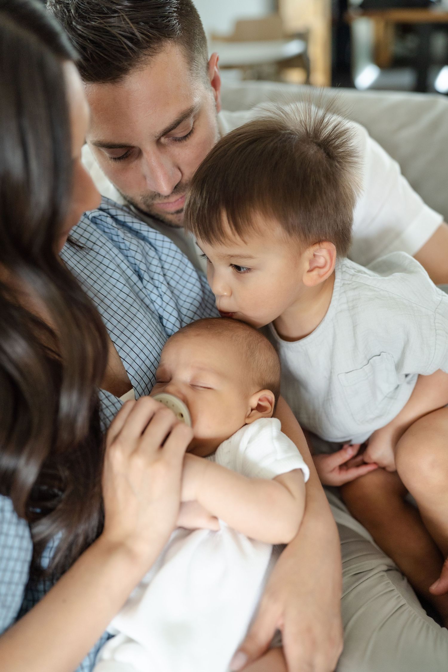 newborn family photo session in nursery, family wearing neutral tones