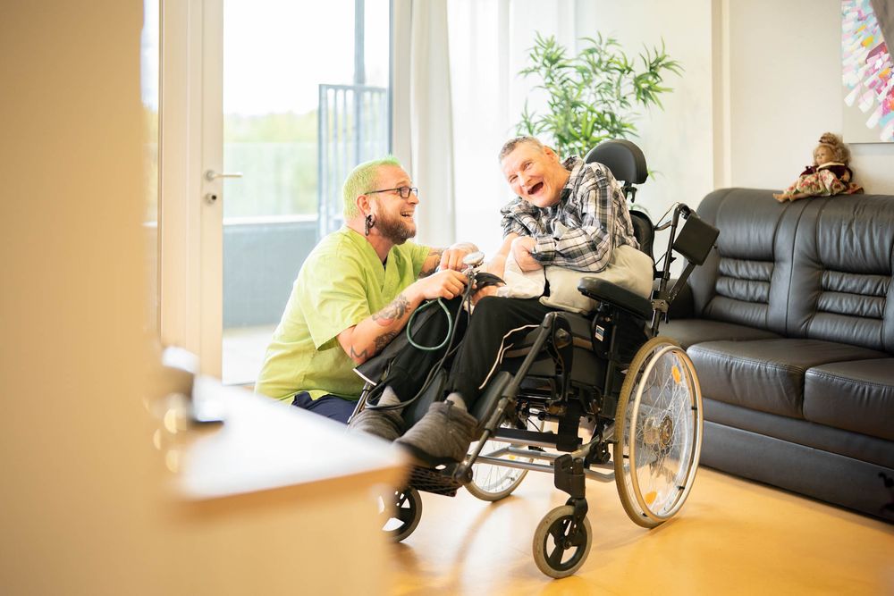 A series of five connected photos showing a person exercising with a wheelchair in a sunny indoor room.