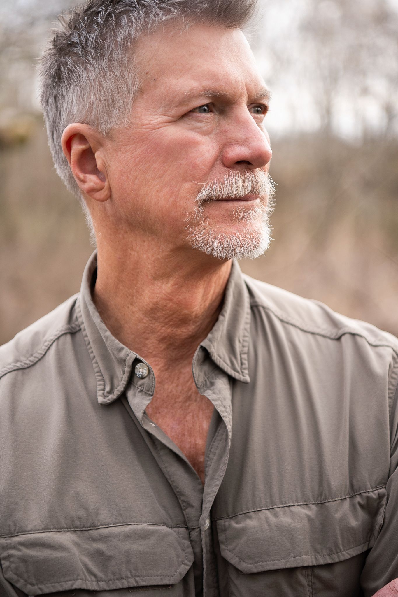 A series of profile views showing an older man with gray hair and mustache wearing a gray collared shirt looking to the side.