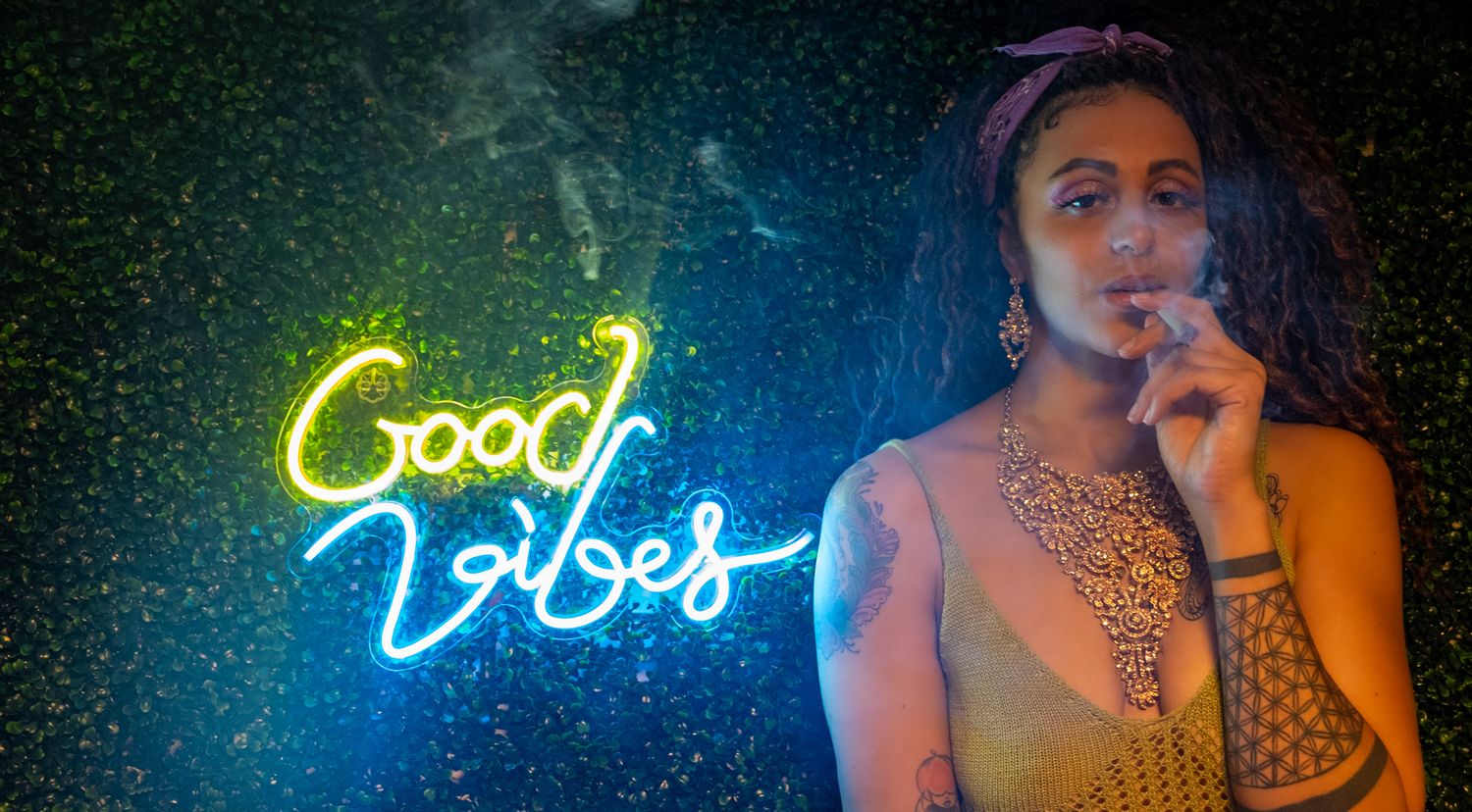 A neon blue sign glowing in a dark room with atmospheric lighting and ambient shadows.