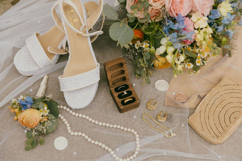 Wedding styling details including pearls, flowers and vintage-inspired accessories.