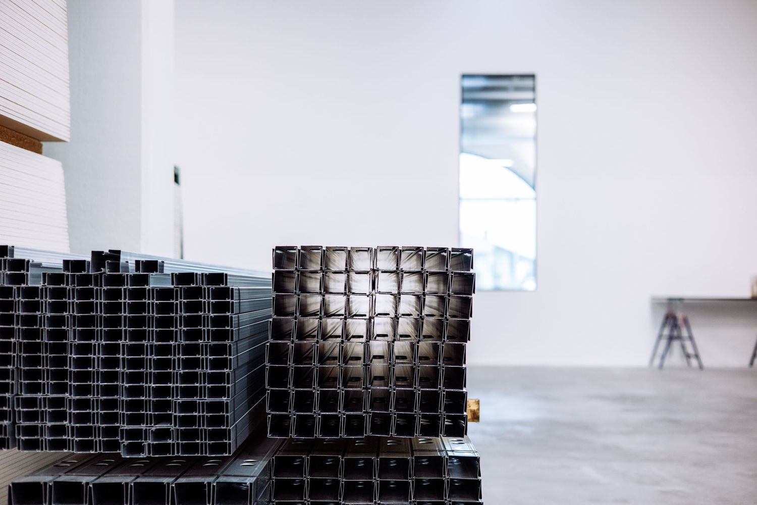 Abstract art installation featuring black geometric cube structures arranged in a minimalist white gallery space.