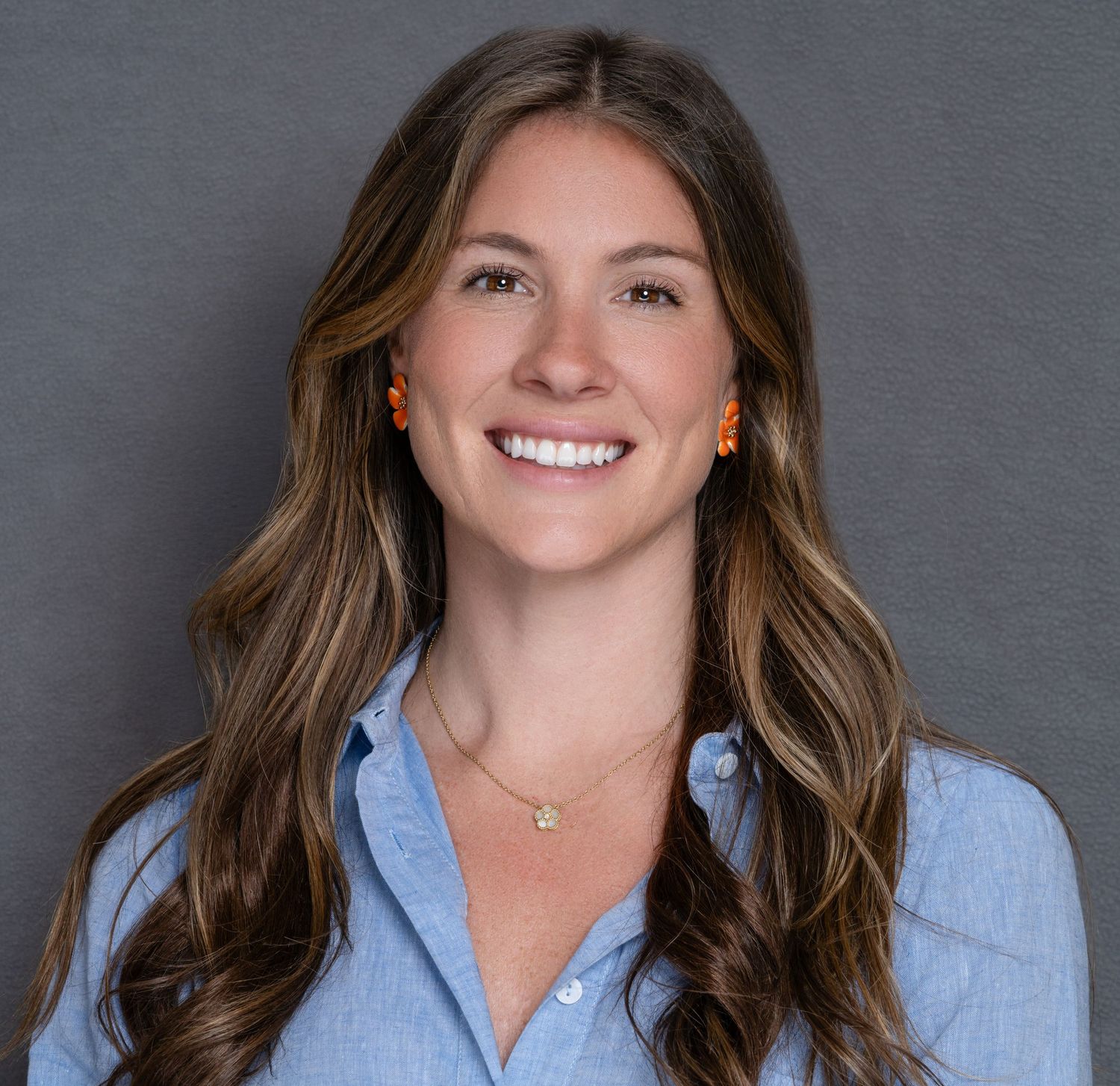 Professional headshot portrait of a women with long wavy brown hair in Charleston, SC