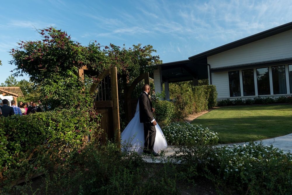 An outdoor wedding photographs showing garden venue settings and scenic moments under blue skies.