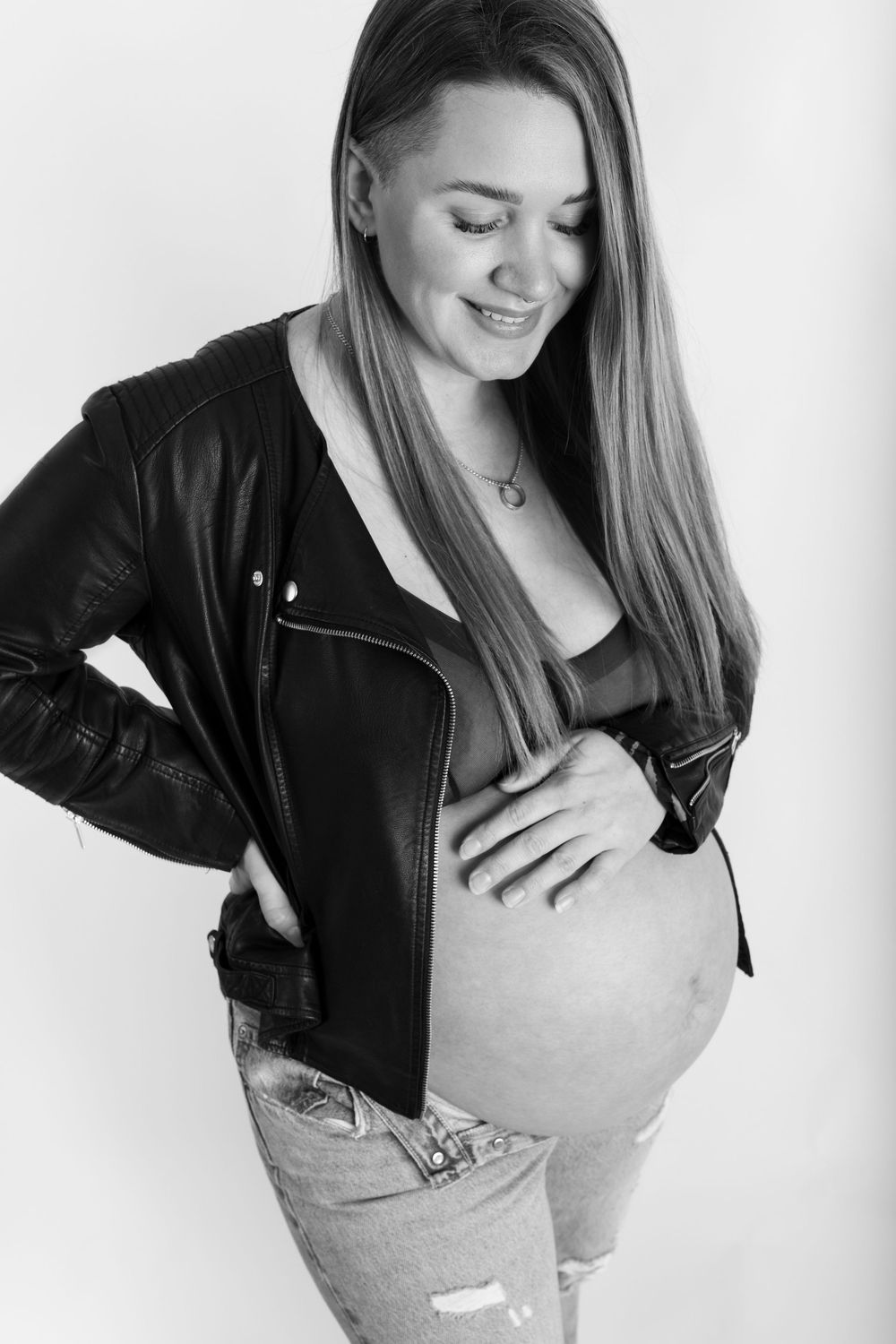 Black and white photo series showing someone in a leather jacket and light colored top posing against white background.