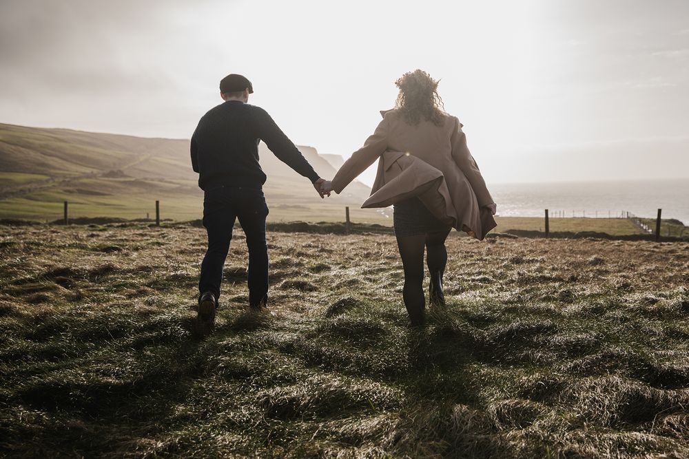 Cinematic storytelling couple session during sunset at Doolin Cliff Walk and Cliffs of Moher in Ireland