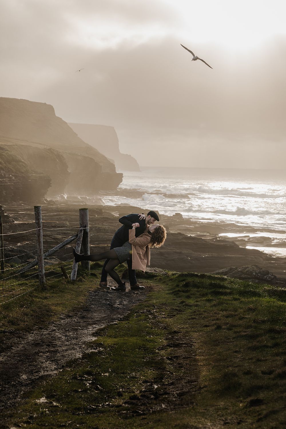 Cinematic storytelling couple session during sunset at Doolin Cliff Walk and Cliffs of Moher in Ireland