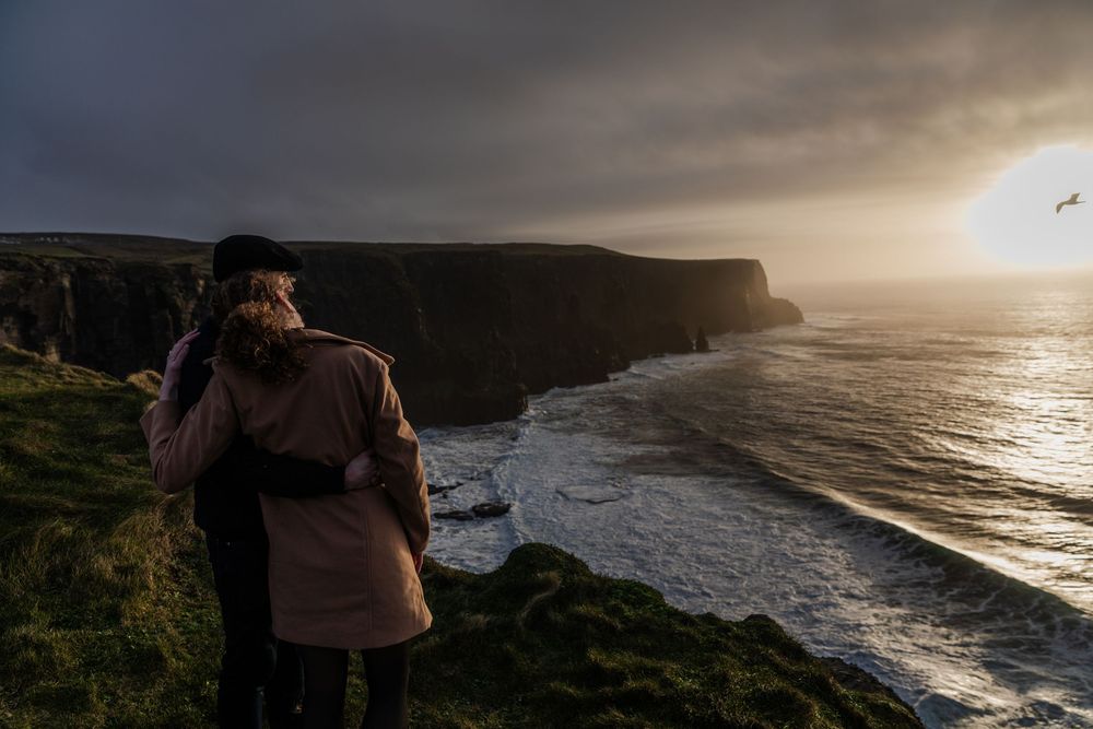 Cinematic storytelling couple session during sunset at Doolin Cliff Walk and Cliffs of Moher in Ireland