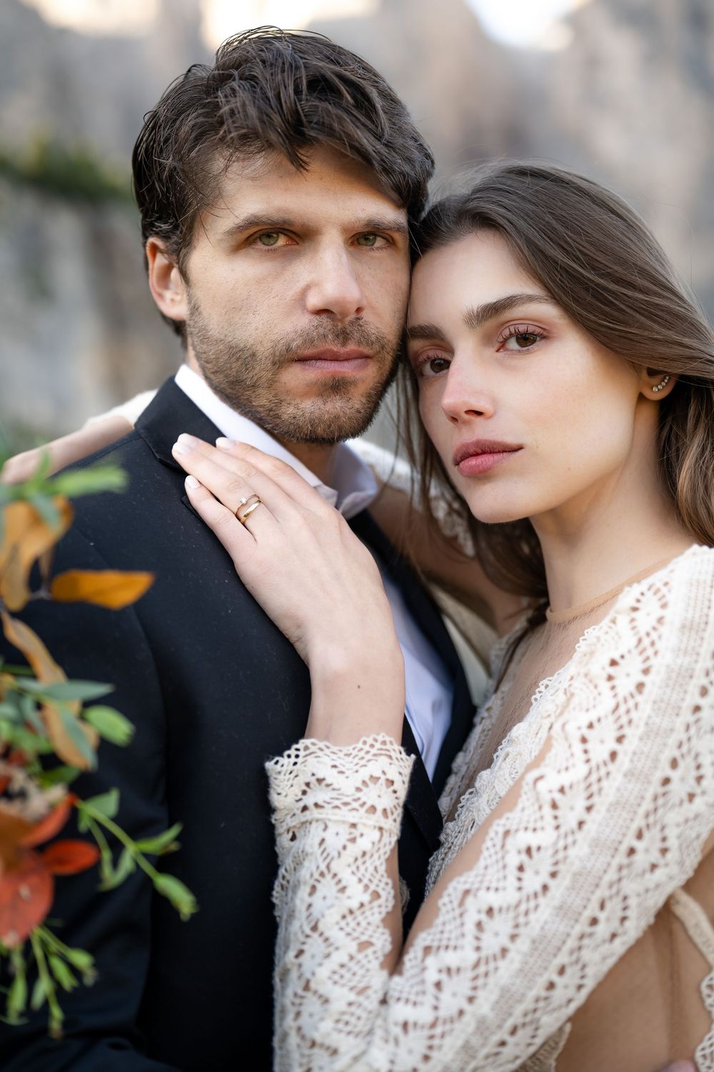 A romantic wedding couple embraces in four intimate close-up portraits showing tender moments and lace details.