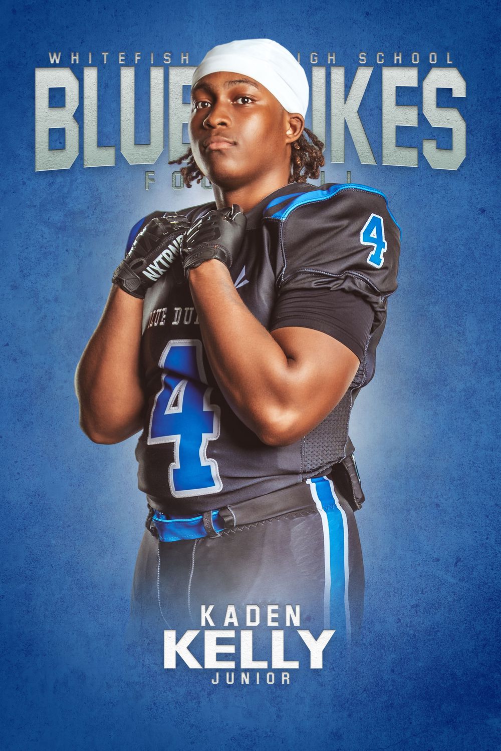 High school football player poses in blue and gray uniform with number 4 against blue background.