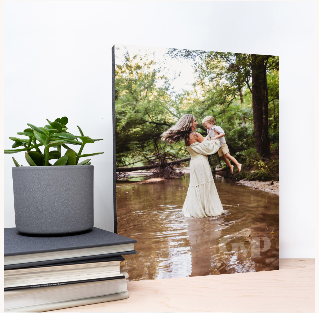 Elegant white dress flowing in nature by a stream with lush greenery and modern concrete planters.