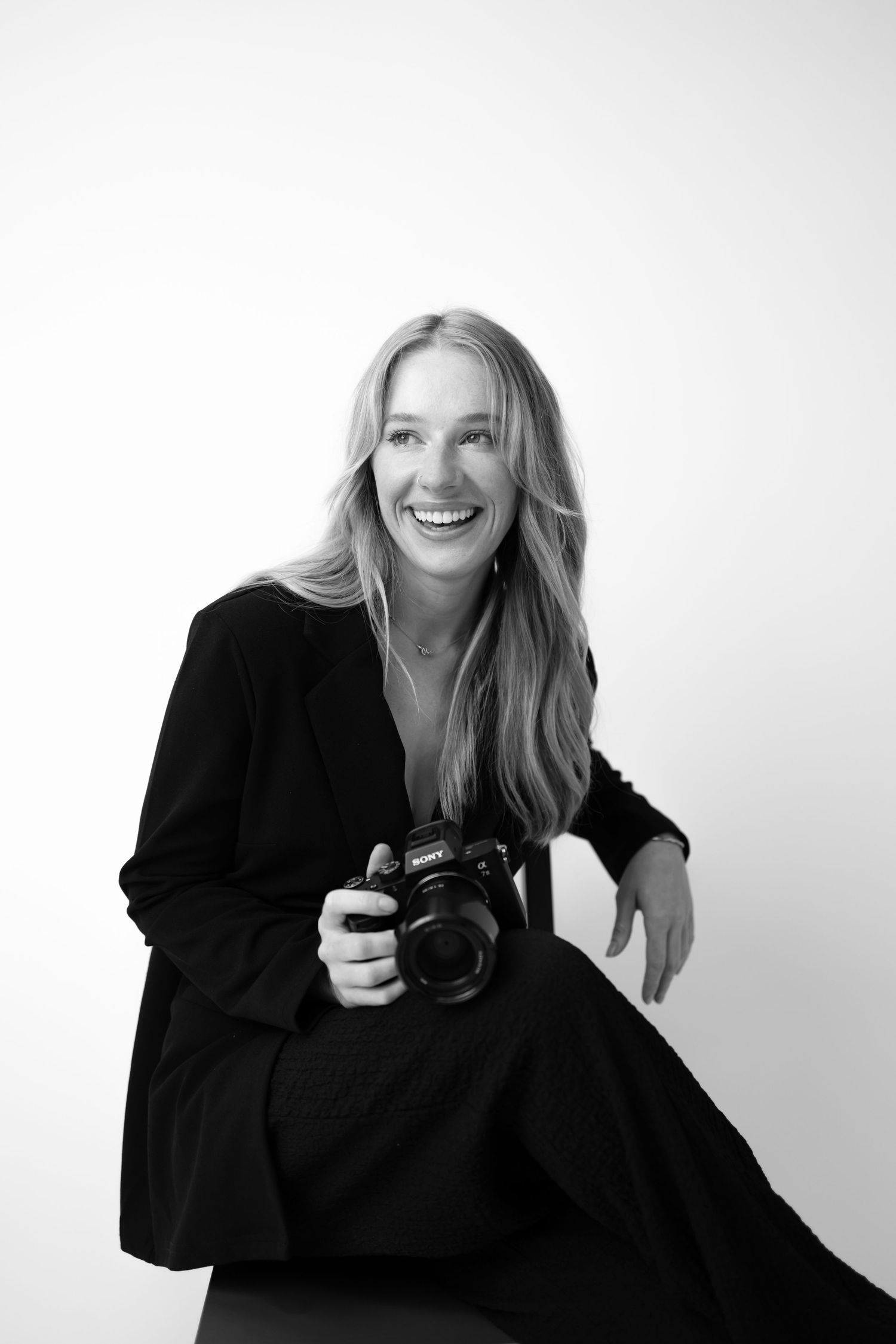 A series of black and white portraits showing a person in a black sweater against a light background.