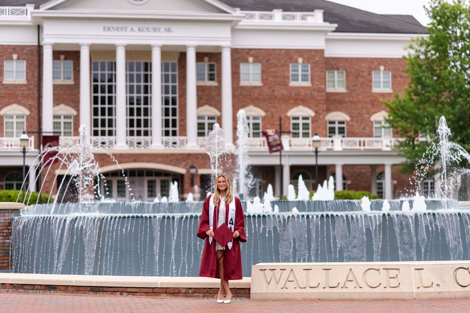 A red brick building entrance with 'The University of North Carolina at Charlotte' signage and walkway.