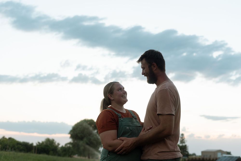 candid photo of two people at sunset