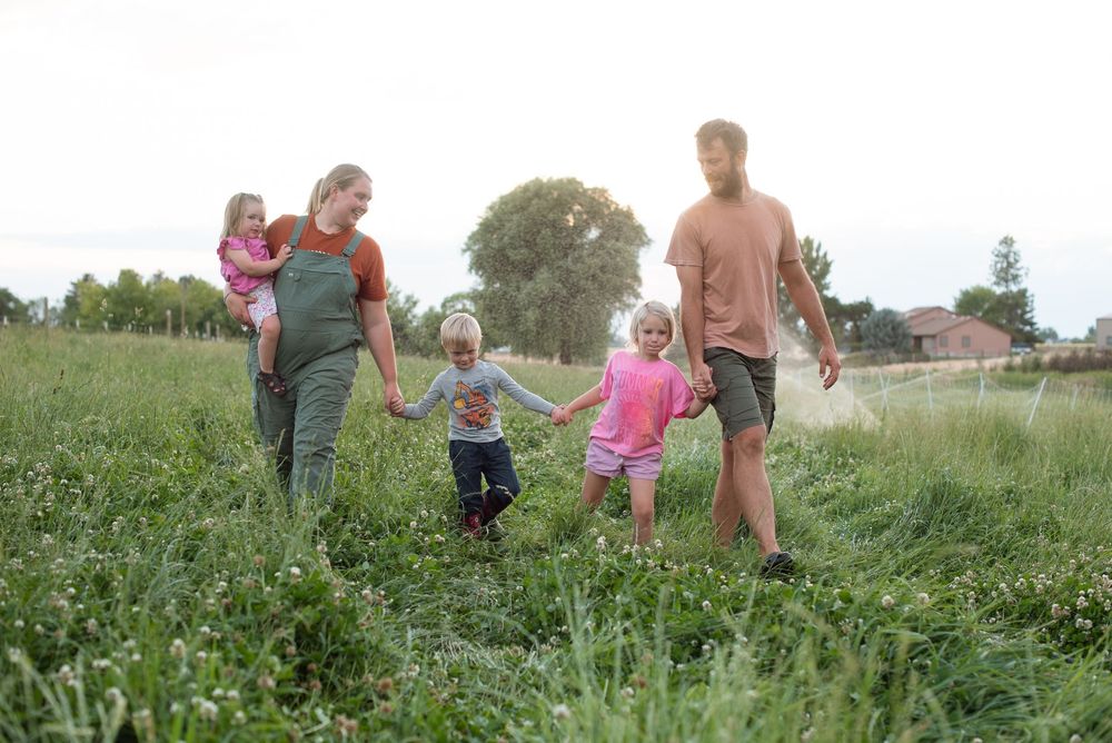 family on a ranch at sunset