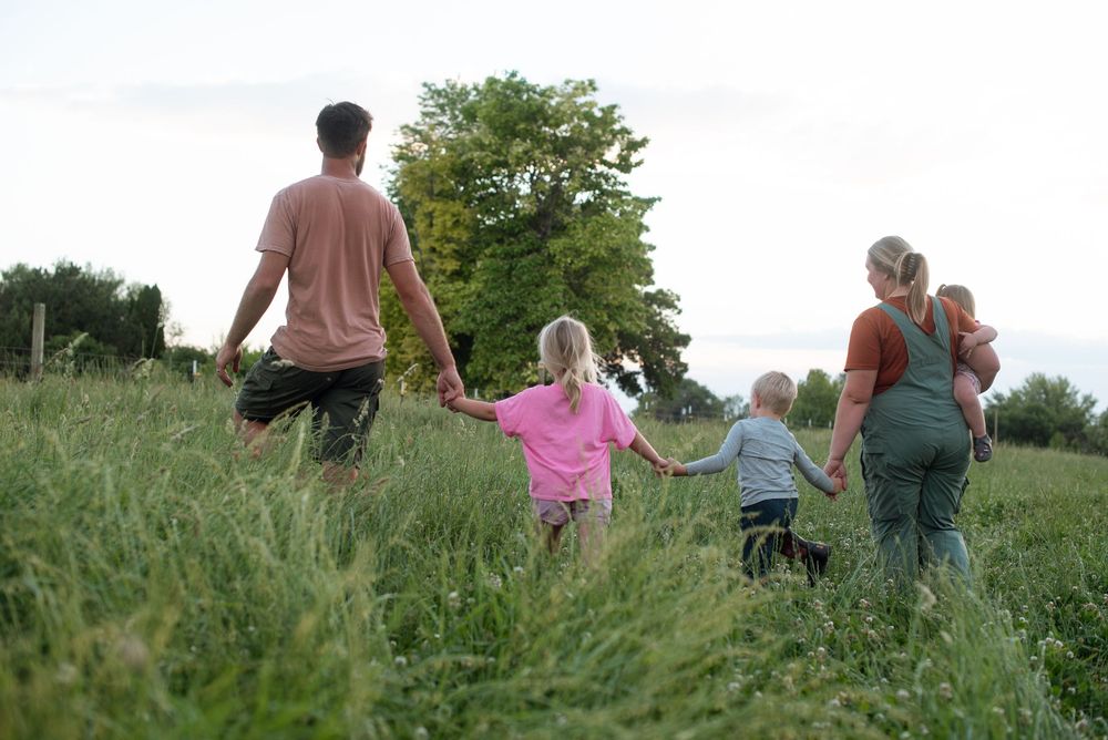ranchers holding hands with their family in idaho