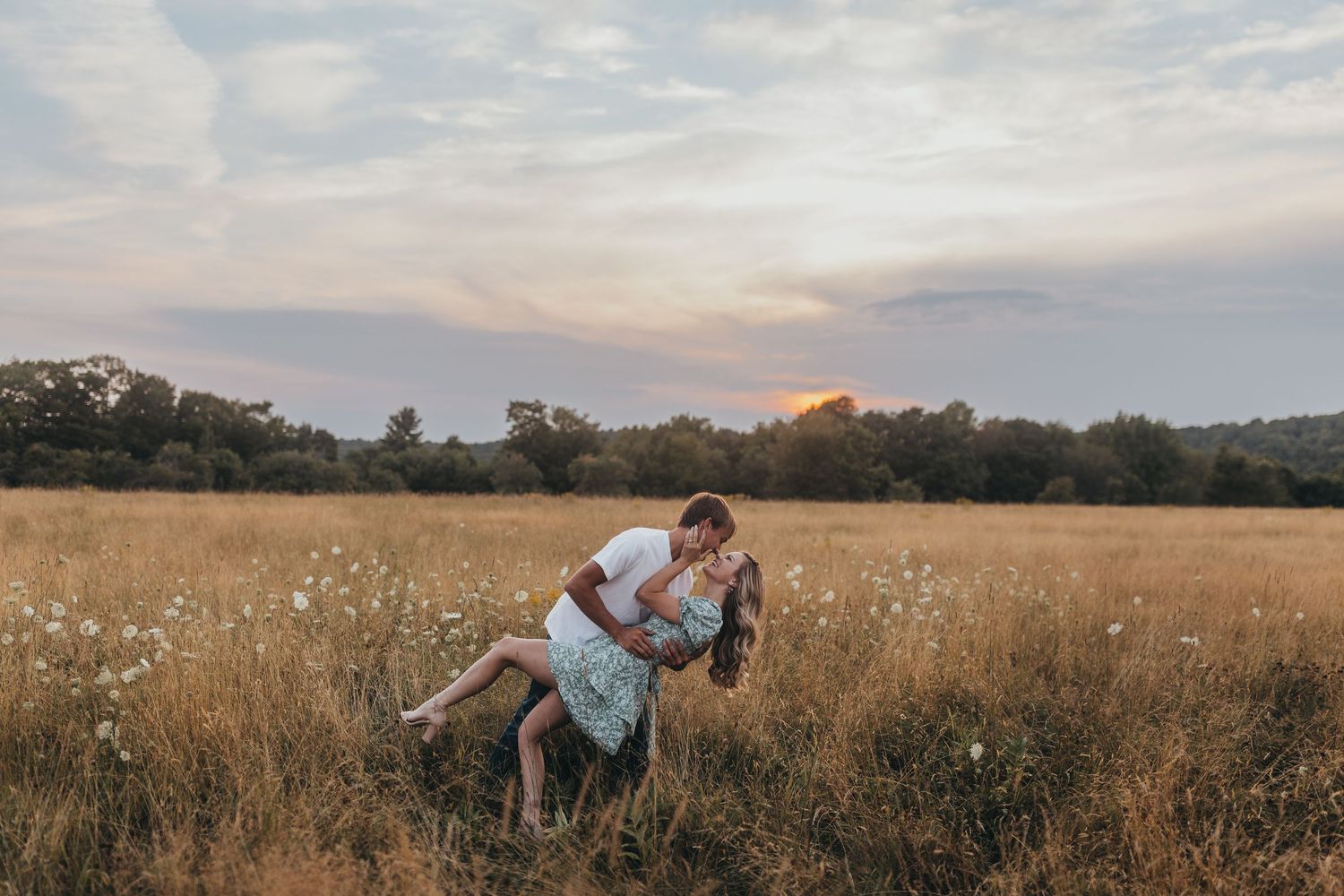 Golden field at sunset with tall grass swaying in the breeze.