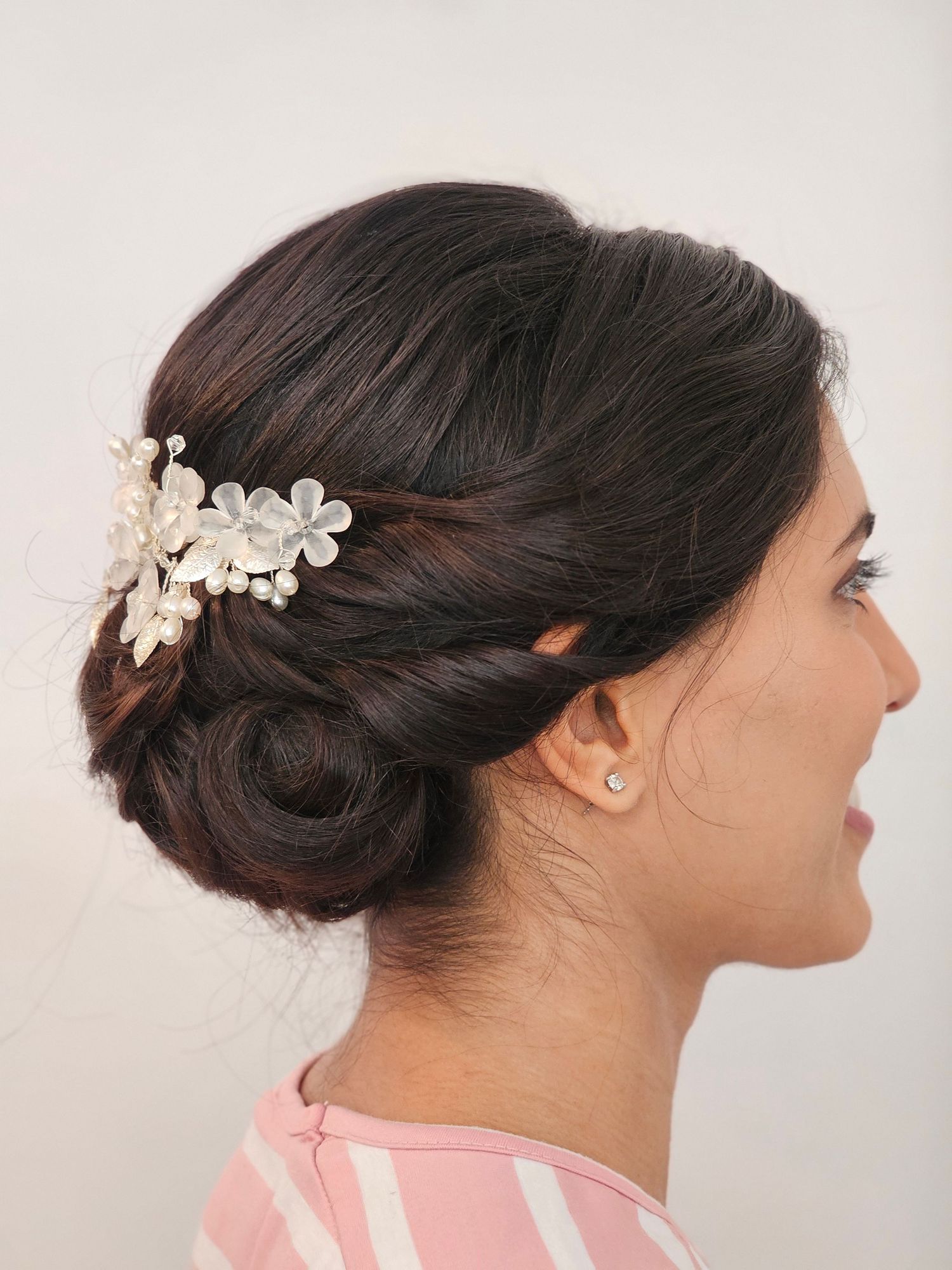 Low chignon bun with softly twisted back hair