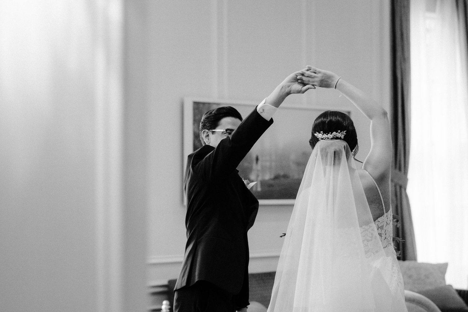 A series of black and white photos showing someone adjusting a bridal veil in different poses.
