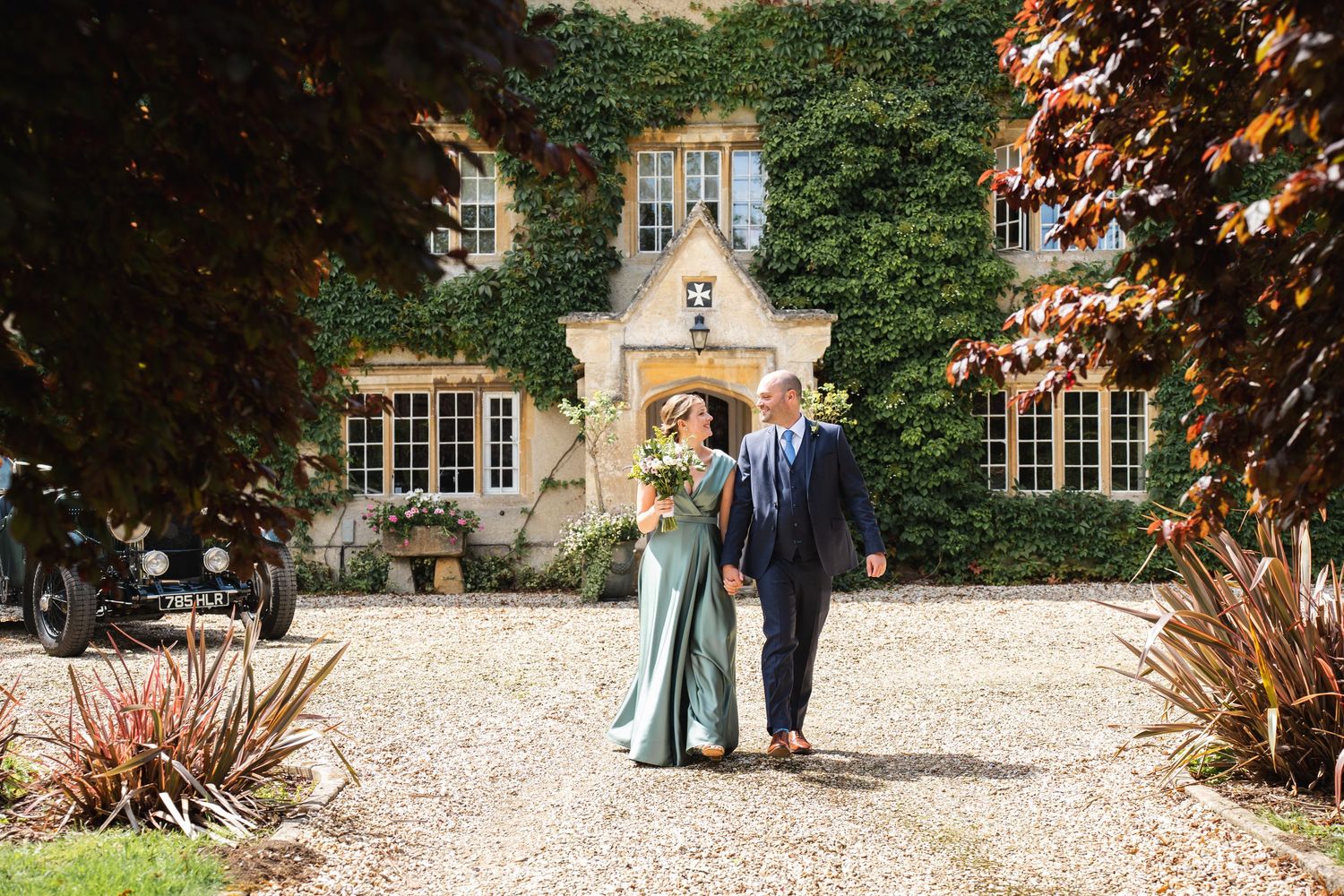 Friars Court Wedding Photography Clanfield with Bride & Groom walking up the road
