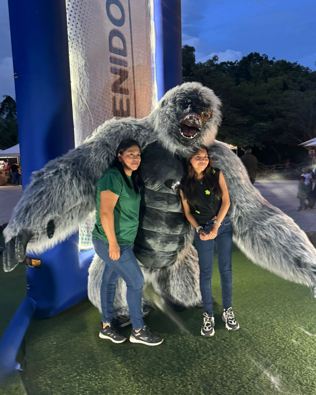 A playful sequence of photos showing people interacting with a large grey furry creature costume on a grassy area at dusk.