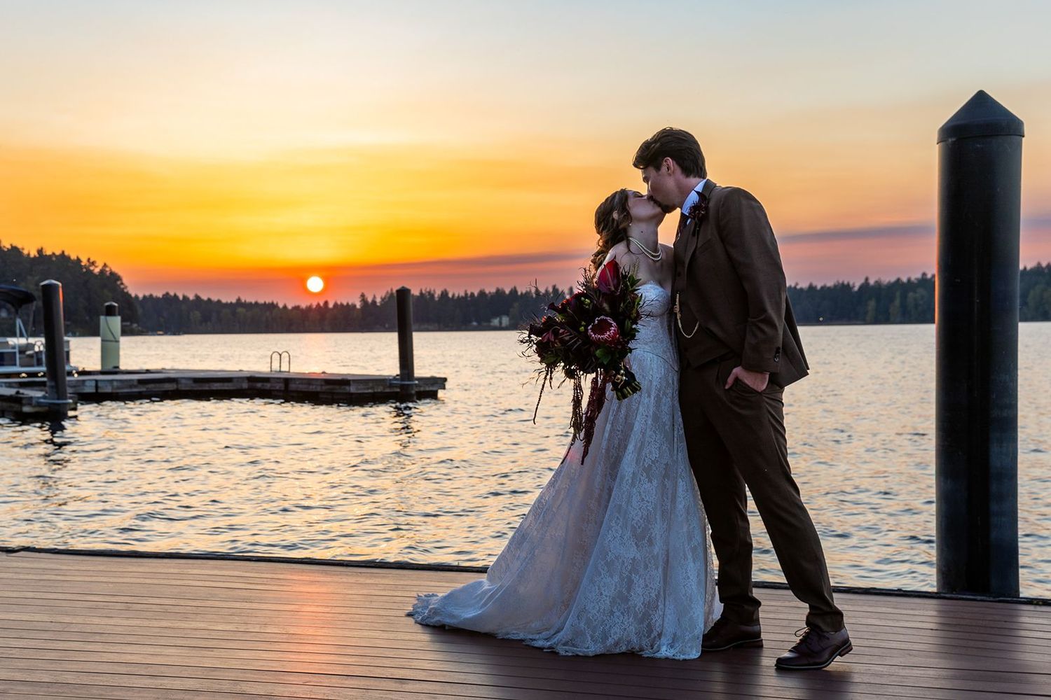 Bride and groom on the boardwalk at the lake at thornewood castle wedding venue