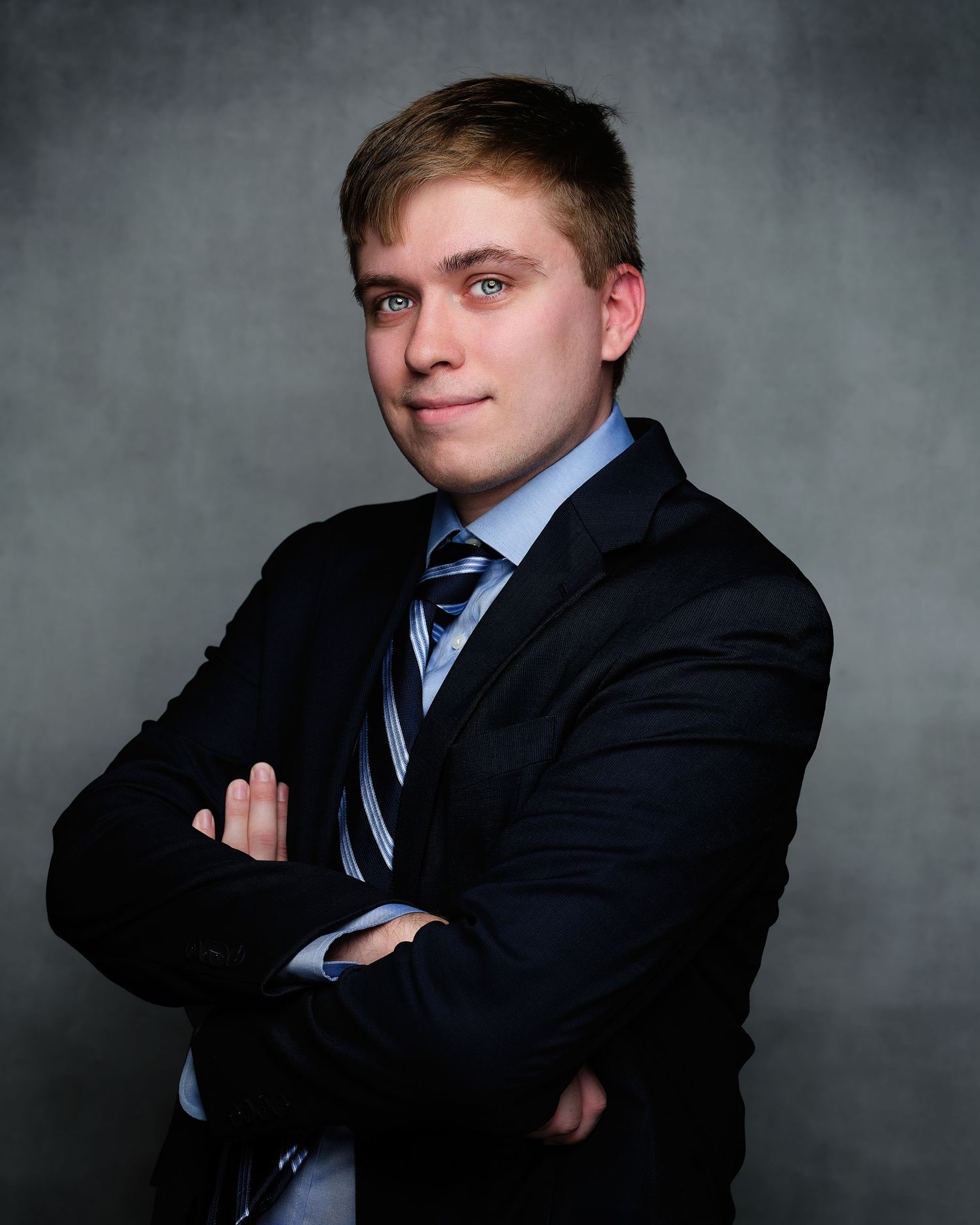 David G Holt Photography - Professional headshots of person in business suit and striped tie against grey background.