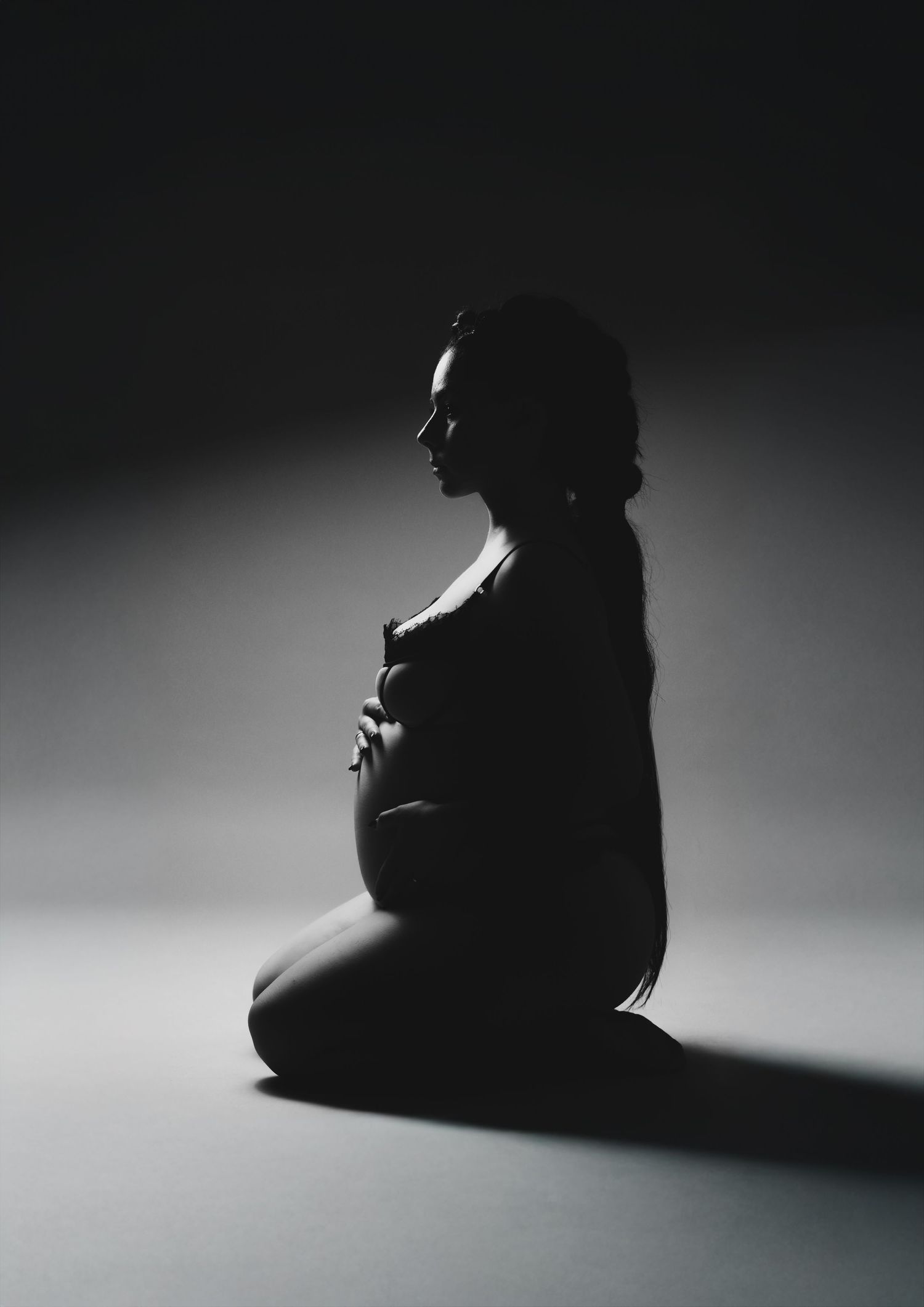 A series of black and white silhouette photos showing a seated figure in dramatic lighting against a gradient background.