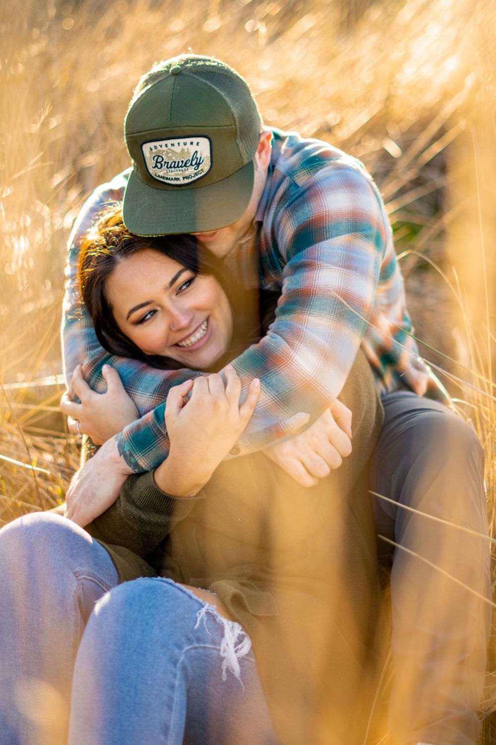 A series of candid photos showing someone in a plaid shirt and baseball cap sitting in golden sunlit grass.