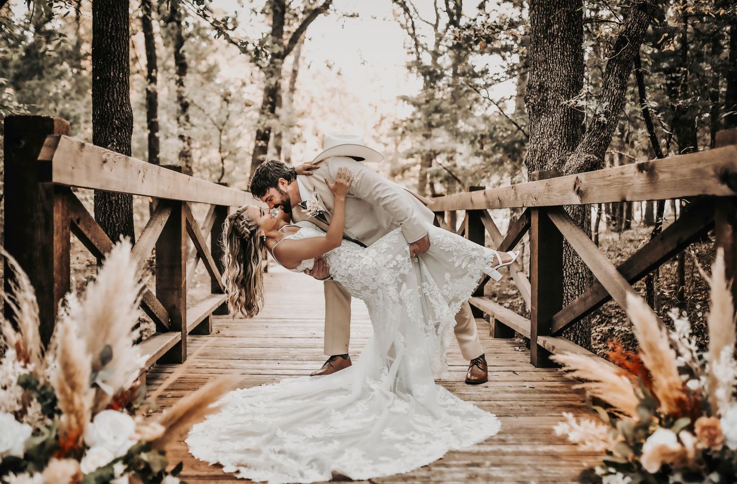 Bride and groom sharing a joyful dip during their wedding celebration
