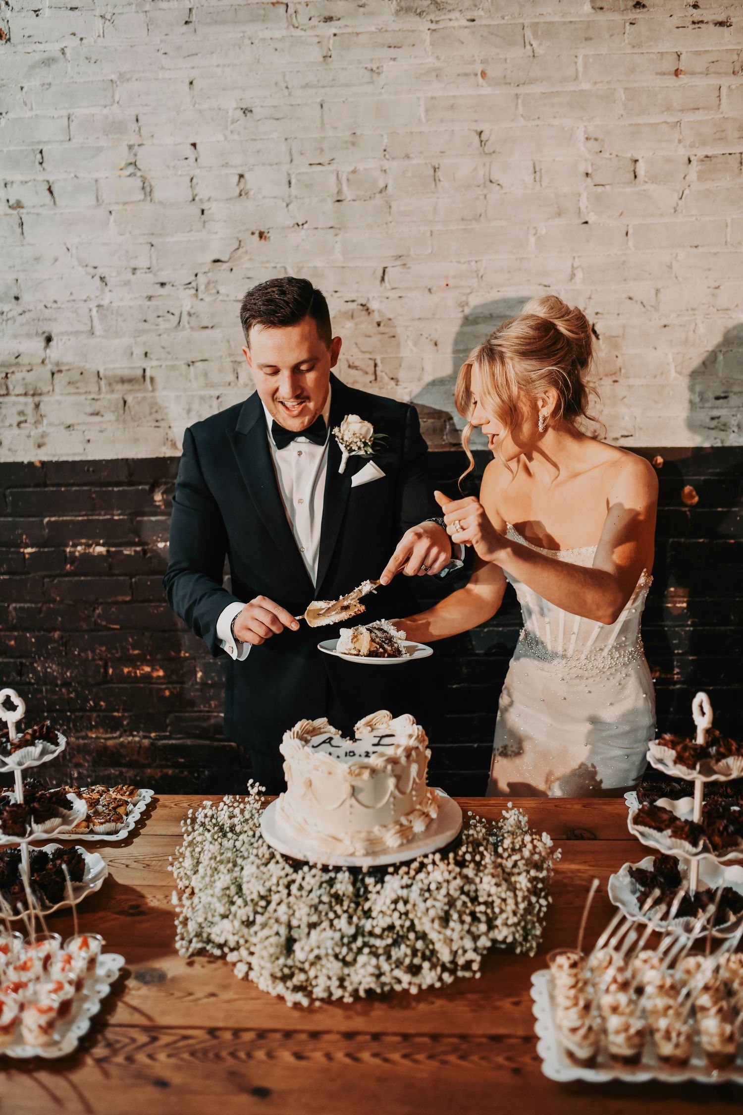Bride and groom cutting wedding cake together