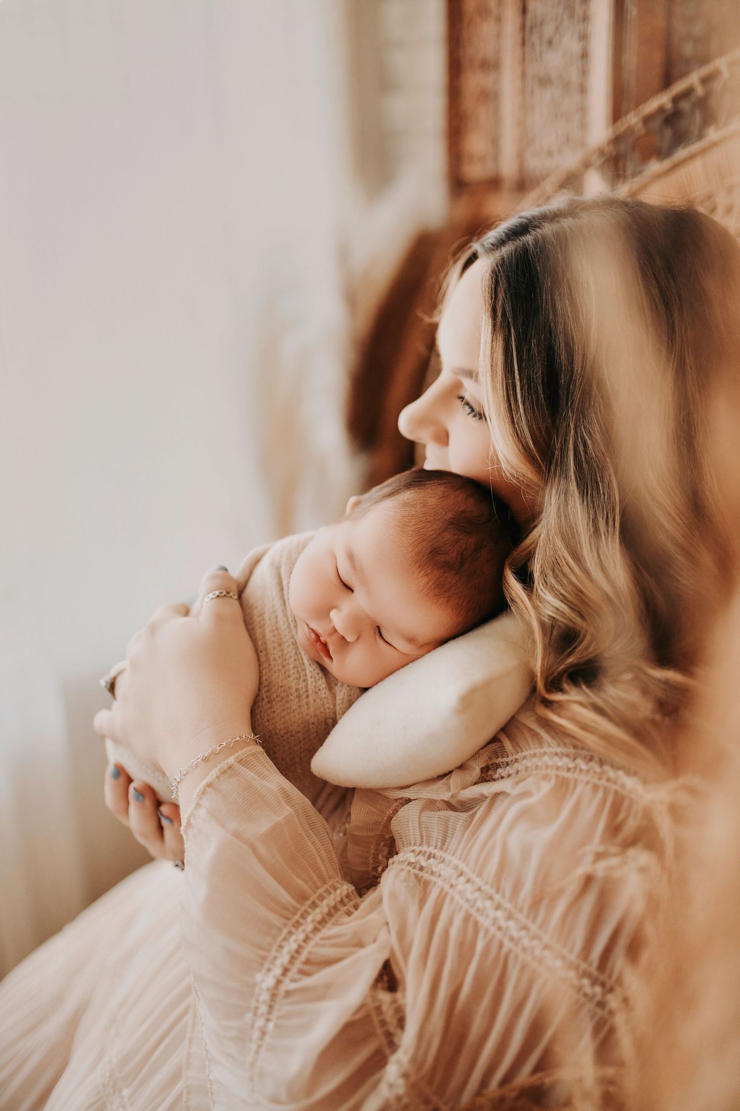 Lifestyle newborn portrait of mother and baby in the studio