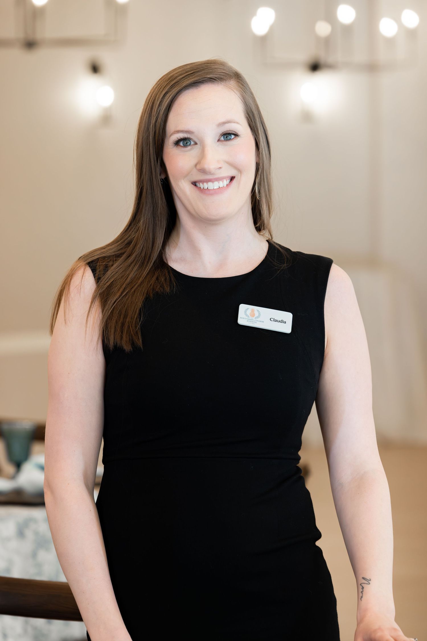 Professional headshot series of a woman in a black sleeveless top smiling against a light colored background.
