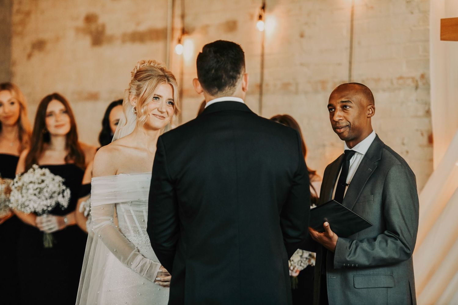 Bride and groom exchanging vows during modern black-tie ceremony