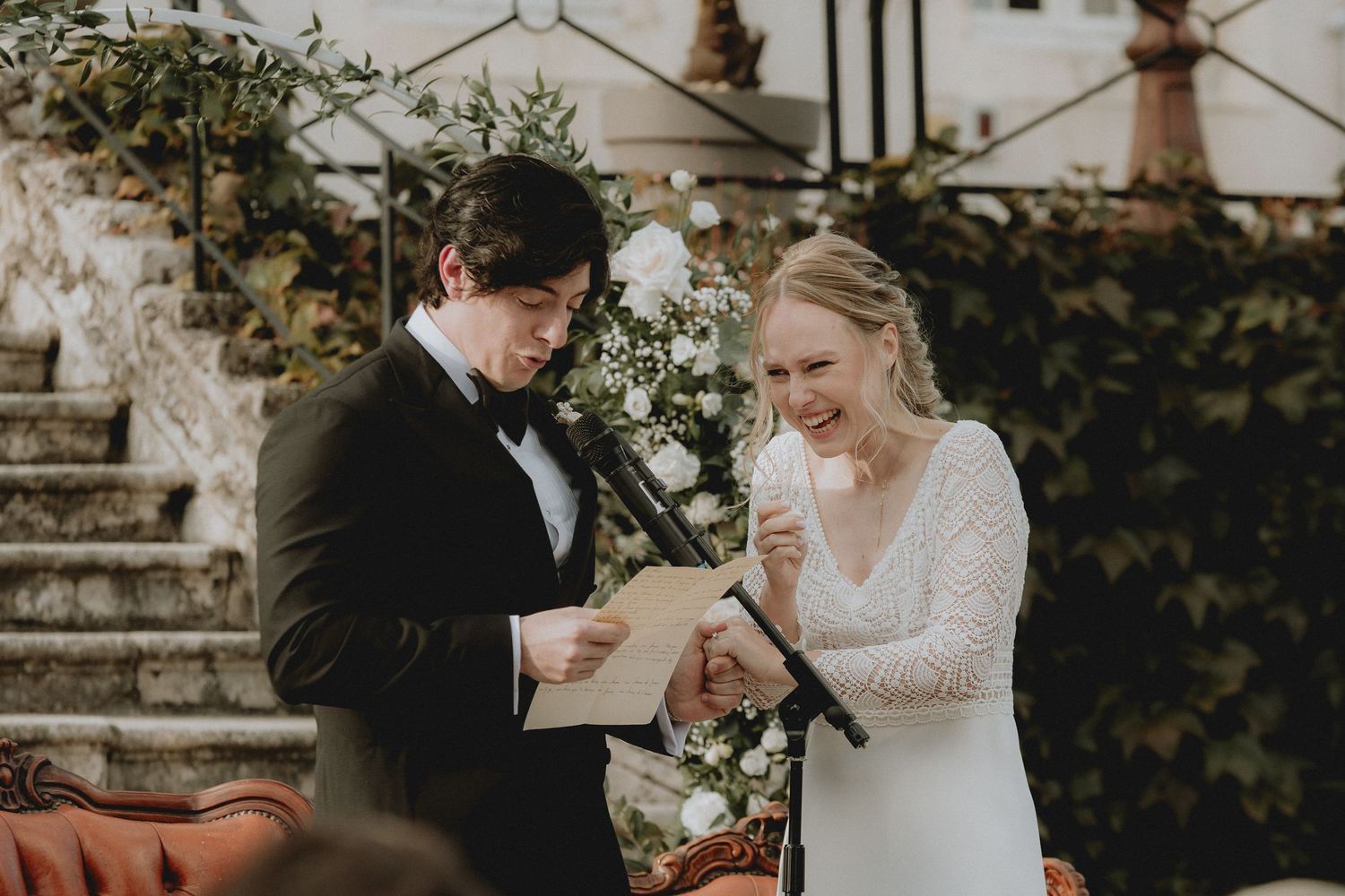 french wedding ceremony outdoor chateau de Vandeleville. Groom in black tuxedo and bride in discreet white wedding dress