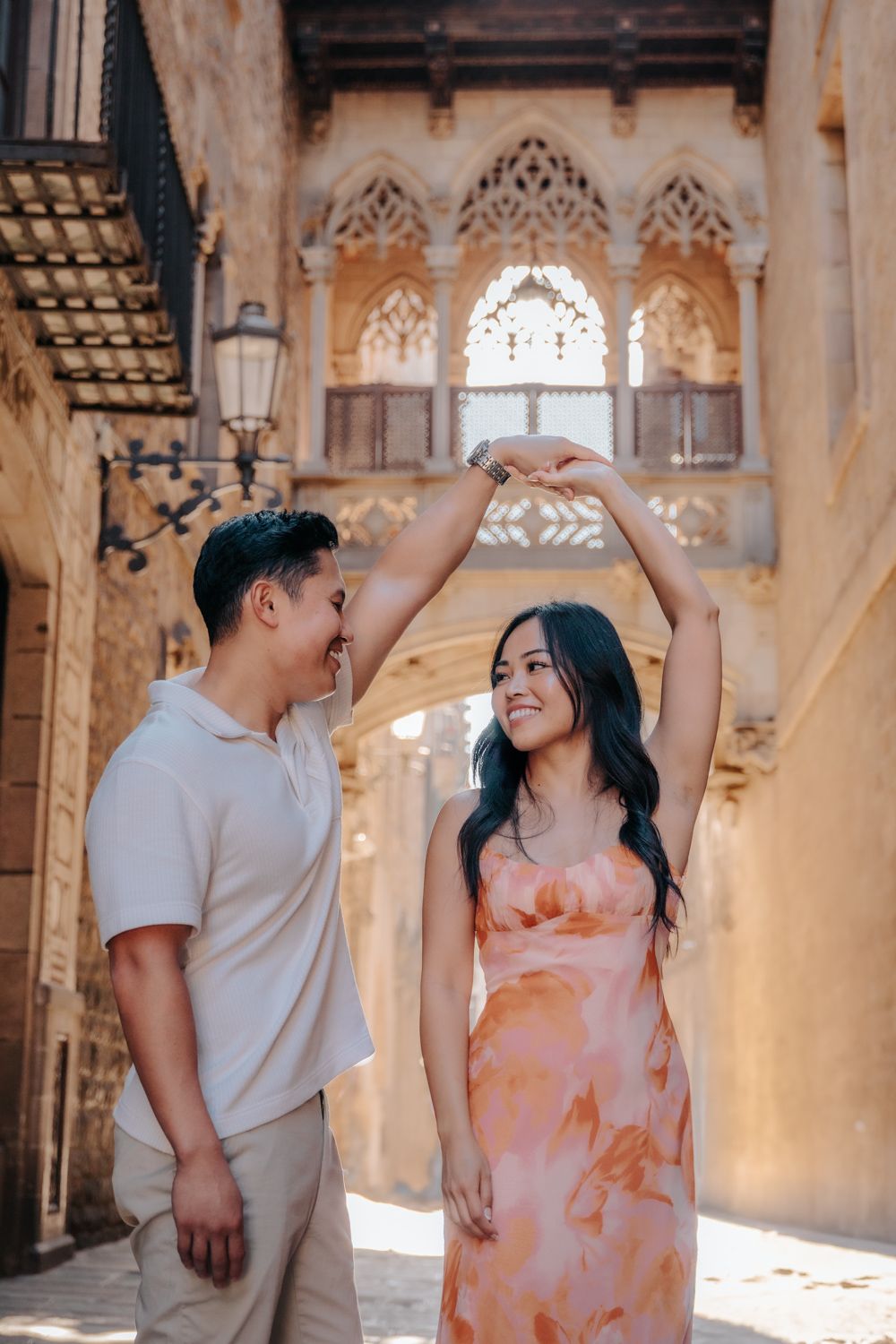 Beautiful architecture of Barcelona framing a happy couple.