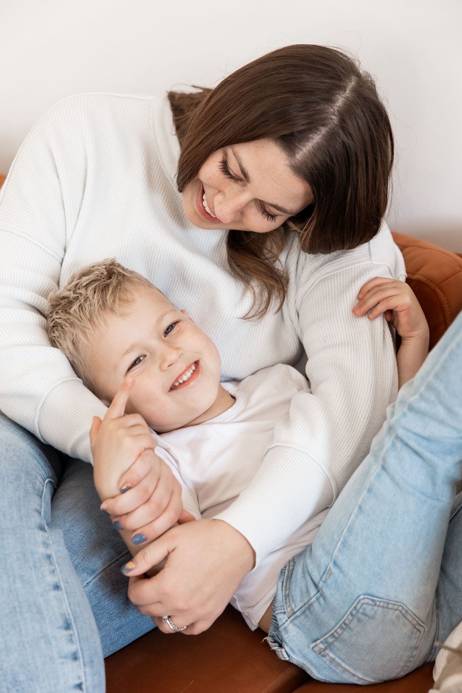 Family shoot with mother and son white bright indoors jeans
