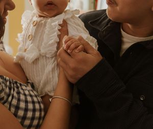 Close-up of intimate family moment in warm indoor lighting.