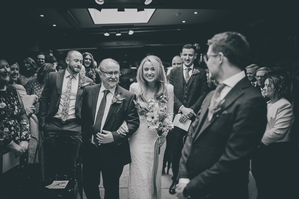 Wedding guests laugh and share joyful moments during an elegant black and white reception celebration.