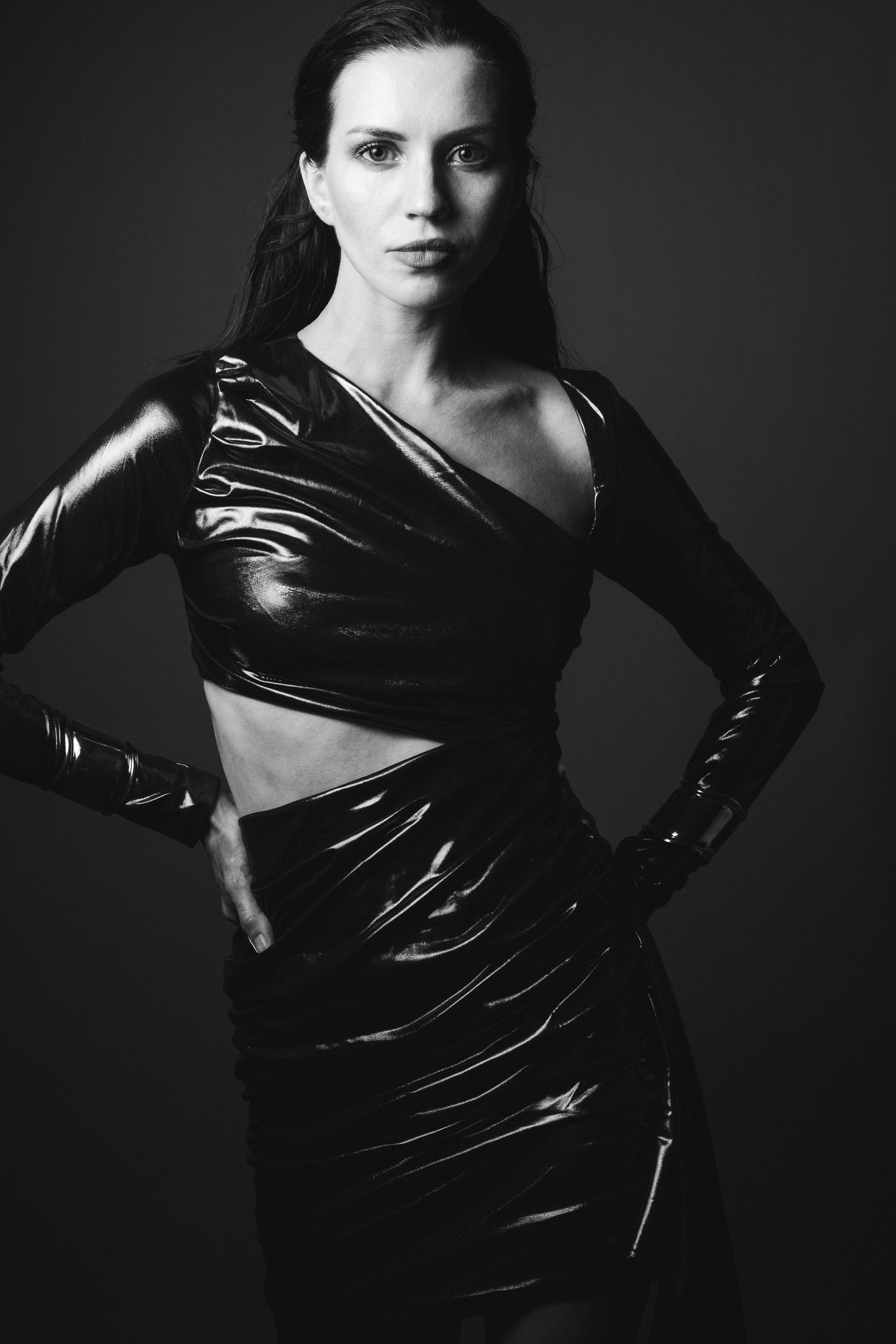 black and white editorial portrait of a woman in an asymmetric shiny dress taken by N-lite Photography in a studio in King's Lynn, Norfolk