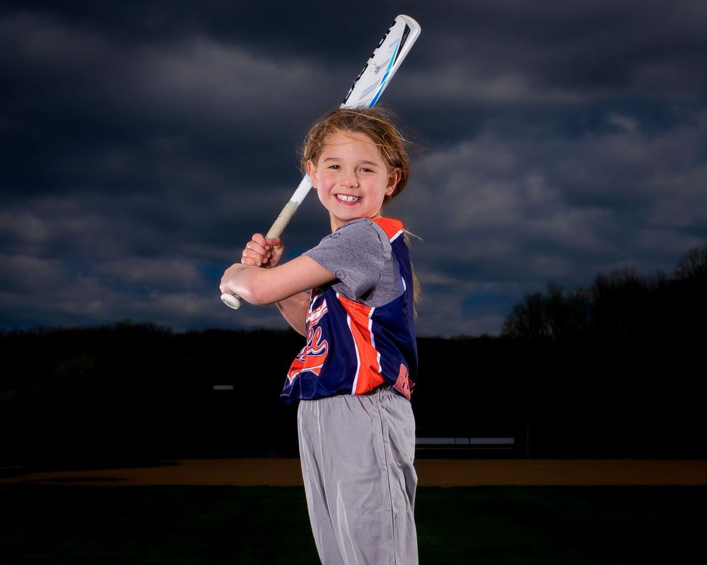 Recreational softball player with dramatic lighting in Hershey PA, photographed by SportsFox Photography.