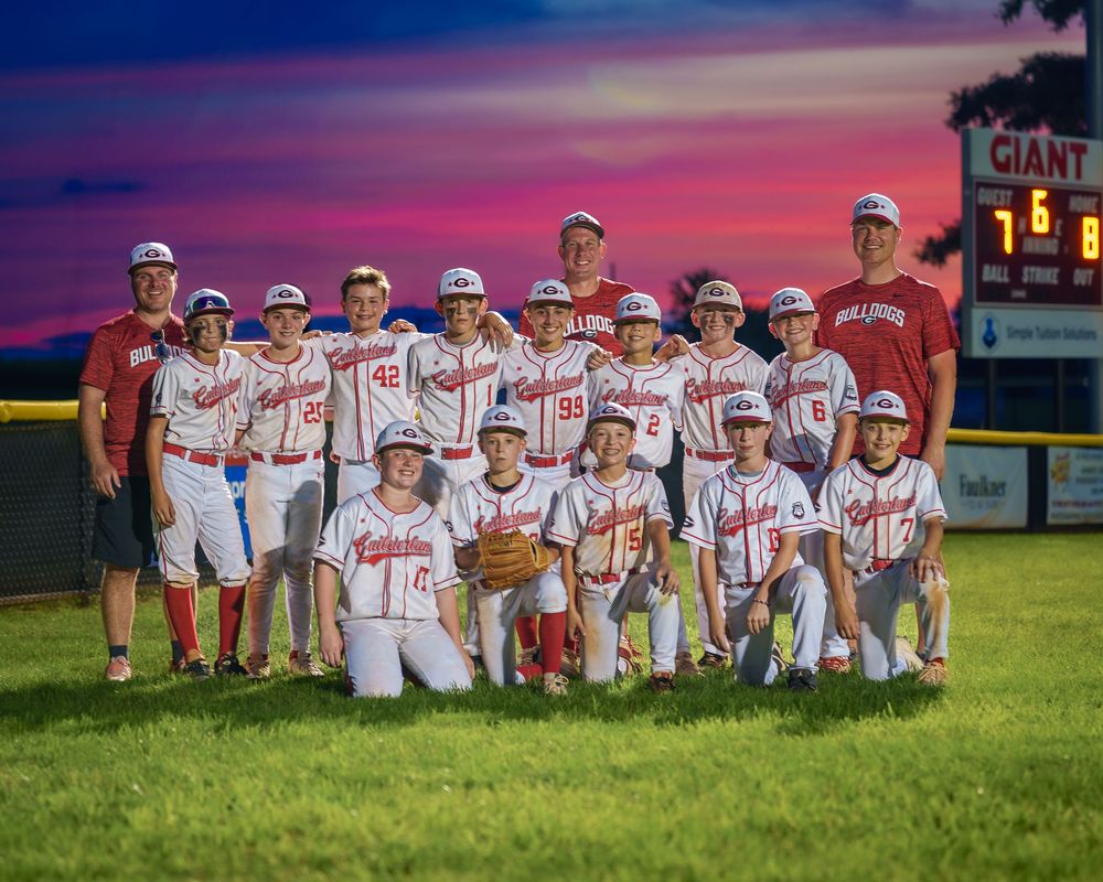 Cal Ripken League baseball team posing in outfield with dramatic sunset Mechanicsburg PA, photographed by SportsFox Photography.