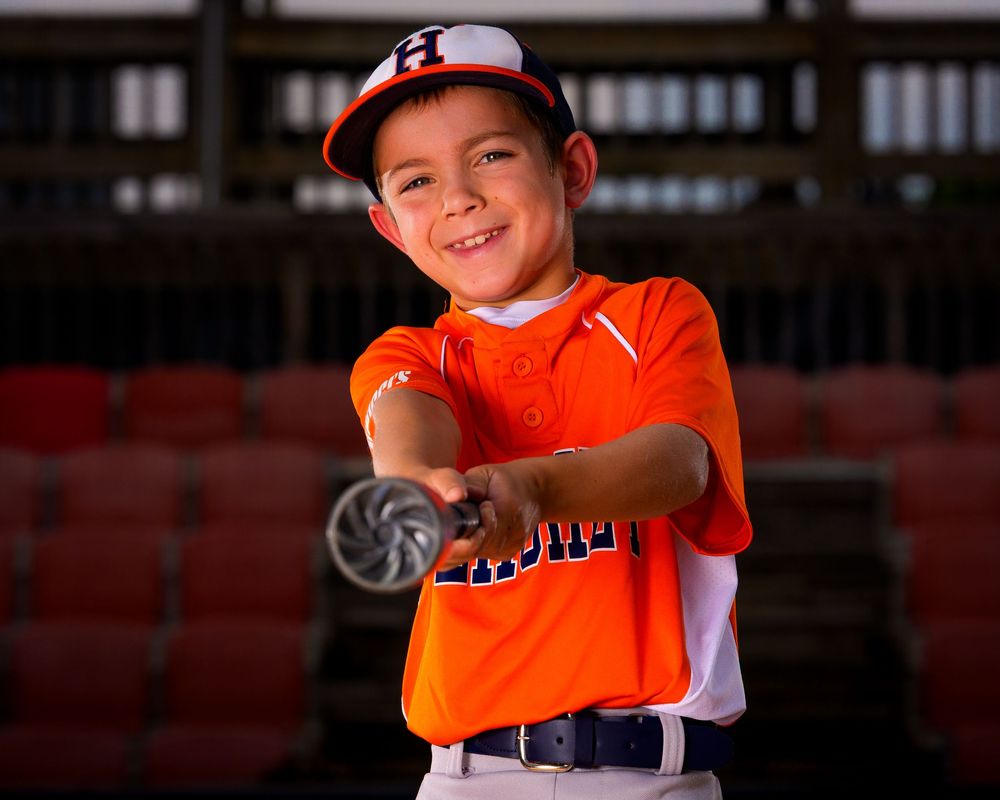 Little League All-Star baseball player posing at home plate with dramatic lighting in Hershey PA, photographed by SportsFox Photography.