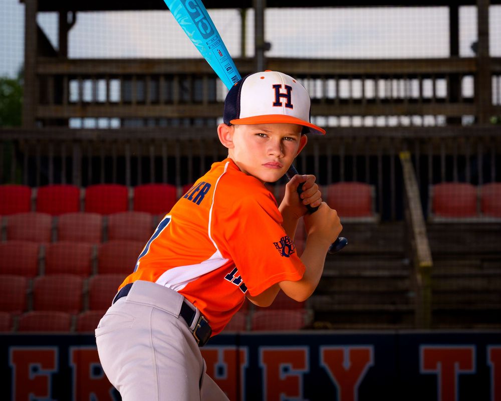 Little League All-Star baseball player posing at home plate with dramatic lighting in Hershey PA, photographed by SportsFox Photography.