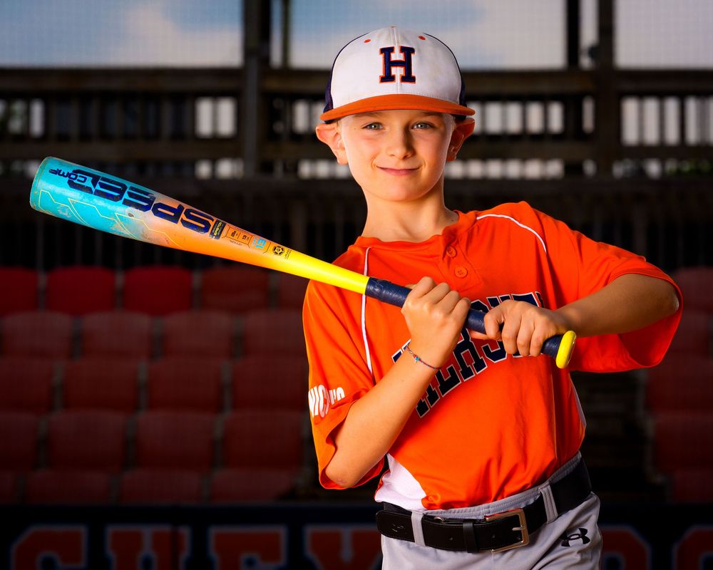 Little League All-Star baseball player posing at home plate with dramatic lighting in Hershey PA, photographed by SportsFox Photography.